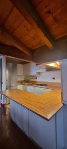 a large kitchen with a wooden counter top at LA MAISON ROSE in Leggiuno