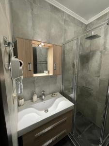 a bathroom with a sink and a shower at Elia House in Chania Town