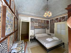 a bedroom with a bed and a chandelier at Stanze al Genio B&B in Palermo