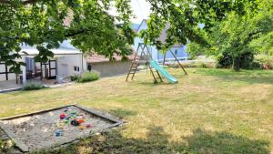 a playground with a slide in a yard at Romantik-Home Nordelsass - Ferienwohnung für Selbstversorger in Oberhoffen-lès-Wissembourg