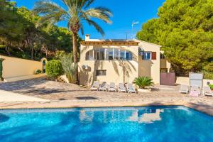a villa with a swimming pool and a house at Villa Enzo - PlusHolidays in Moraira