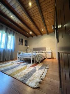 1 dormitorio con cama y alfombra en el suelo de madera en VILLA LAURA en Salceda