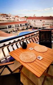 a wooden table with two pizzas on top of a balcony at Diamond Roof in Los Cristianos