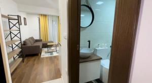 a bathroom with a sink and a toilet in a room at Skopje Kale Luxury Apartment in Skopje