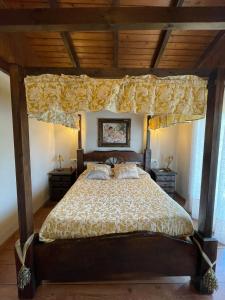 a bedroom with a bed with a canopy at VILLA LAURA in Salceda