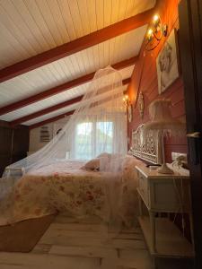 a bedroom with a bed with a mosquito net at VILLA LAURA in Salceda