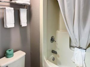 ein Bad mit einer Dusche, einem WC und Handtüchern in der Unterkunft Studio 6 Elkhart IN in Elkhart