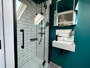 a bathroom with a sink and a shower at 3a Roman View, beautifully appointed apartment in Roundhay, sleeps up to 6, bedrooms with en suite bathrooms, EV charging in Moortown