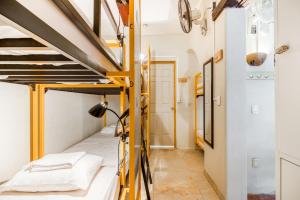a bedroom with bunk beds in a hostel at Nílu Puerto Escondido by Selina in Puerto Escondido +32 photos