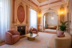 a living room with two chairs and a fireplace at Lilases Boutique House & Garden in Mora +83 photos