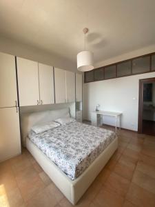 a bedroom with a large bed and a table at Casa LELLA in Rocca di Papa