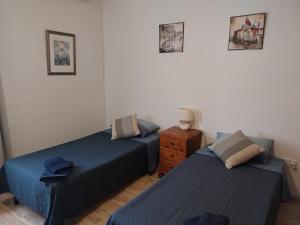 Rúm í herbergi á Homestay Naxxar