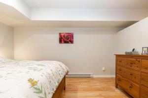 a bedroom with a bed and a wooden dresser at Lovely 1 Bedroom Suite Near Town in Victoria