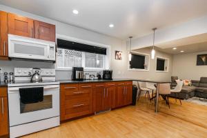 a kitchen with a stove top oven next to a living room at Lovely 1 Bedroom Suite Near Town in Victoria