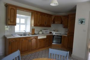 a kitchen with wooden cabinets and a sink at Sally's 