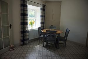 a dining room with a table and chairs and a window at Sally's in Mullanmore +13 photos