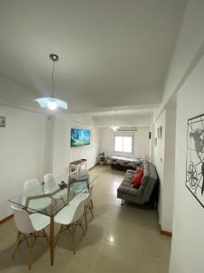 a living room with a glass table and a couch at Efimero San Juan, pleno centro in San Juan
