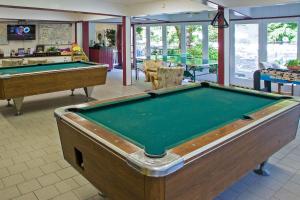 a pool table in a room with two tables at Eagles Nest Escape in Gatlinburg