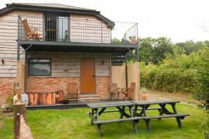 a picnic table in front of a house at Luxury three bedroom property with hot tub in West Wellow