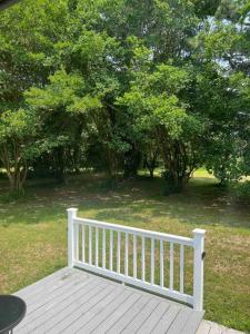 a white fence sitting on top of a wooden deck at Newly renovated rancher with yard and garage! Furnished! in Williamsburg