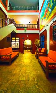 a room with couches and tables and a room with a unintention at Hostel Sillustani Inn Puno in Puno