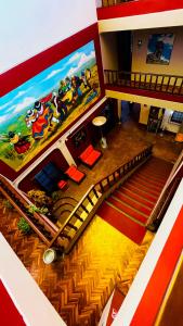 an overhead view of a staircase with a painting on the wall at Hostel Sillustani Inn Puno in Puno