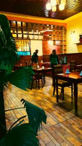 two people sitting at tables in a restaurant at Hostel Sillustani Inn Puno in Puno