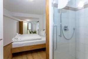 a bedroom with a bed and a shower at Villa Oberbichl in Piesendorf