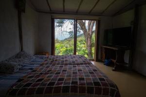 En eller flere senge i et værelse på Ecolodge Jaguarundi
