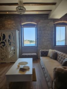 a living room with a couch and a table at Luxury Seafront Suite Fabri in Vis