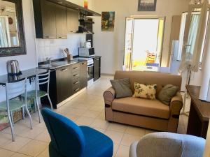 a living room with a couch and a kitchen at A View 2 Sea in Parghelia