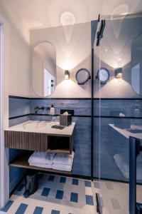 a bathroom with a sink and a mirror at Hotel Du Parc in Ostend
