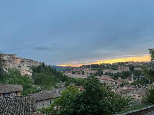 a view of a city with the sunset in the background at L'attico del 1600 in centro in Perugia