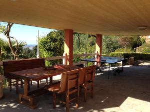 a wooden table and chairs on a patio at Baita Chalet del Colle in Corsanico-Bargecchia