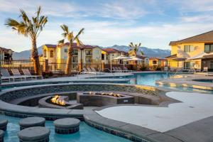 a pool at a resort with a fire pit at Zion PLAY-cation Home - VIEW of Zion National Park in Hurricane