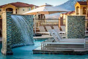 a pool with chairs and a water fountain at Zion PLAY-cation Home - VIEW of Zion National Park in Hurricane