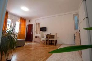 - un salon avec une table et une salle à manger dans l'établissement Centar stan na dan za do 4 osobe, à Novi Sad