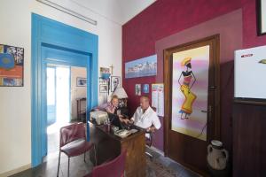 two people sitting at a counter in a room at Centrale in Trapani