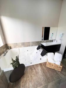 a bathroom with a white tub and a sink at 1714 Hotel Boutique Guatapé in Guatapé