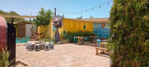 a patio with a table and chairs in a yard at CG glamping in San Felipe