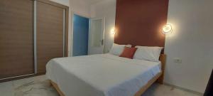 a bedroom with a large white bed with two lamps at Atonika Apartments Bitola in Bitola +28 photos