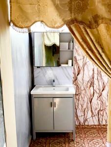 a bathroom with a sink and a mirror at Podi Hoona Luxury Bush Camp in Yala