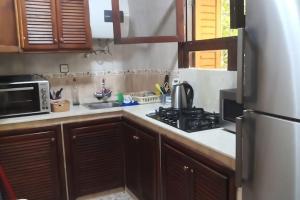 a kitchen with a stove and a microwave at Casa Mima in Tétouan +2 photos