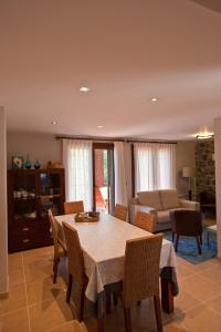 a dining room with a table and chairs and a couch at Segotegi Etxea in Orio