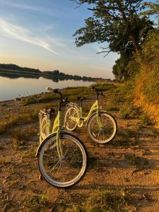 two bikes parked next to a body of water at Ośrodek konferencyjno-wypoczynkowy in Chojna