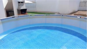 a large blue swimming pool in a building at Anchor House in Albufeira