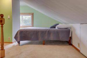 a bedroom with a bed in the attic at Cozy Westmont Home Walk to Metra Station! in Westmont