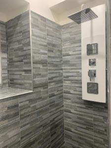 a bathroom with a shower with wooden tiles at Loft Home Sweet Home in Catania