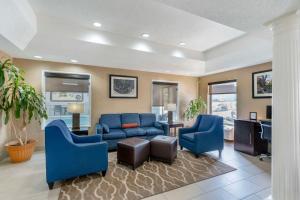 a living room with a blue couch and chairs at Comfort Inn & Suites in La Grange