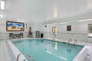 a large swimming pool in a building at Comfort Inn & Suites in La Grange